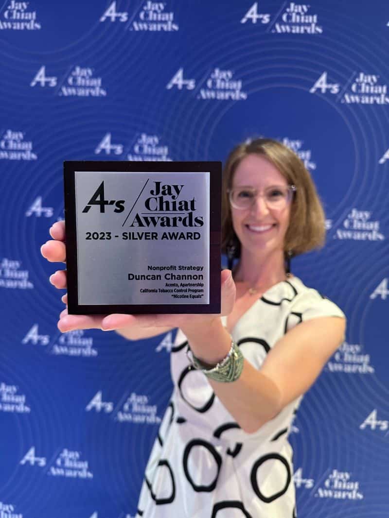Director of brand strategy, Kelleen Peckham, holds the silver award for the Jay Chiat award presentation.